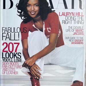 Könnte beinhalten: Ein Harper's Bazaar Magazin-Cover mit Lauryn Hill in einem roten Kurzarm-Oberteil, einer weißen Hose und roten Stiefeln. Der Text lautet: Harper's Bazaar, Lauryn Hill Doing The Right Thing, The Double Life Of Marc Jacobs, Fabulous Fall.