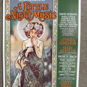 May include: A vintage theater poster for "A Little Night Music" featuring a woman in a flowing gown with a floral headdress. The poster has a green border and includes the names of the cast, crew, and theater.
