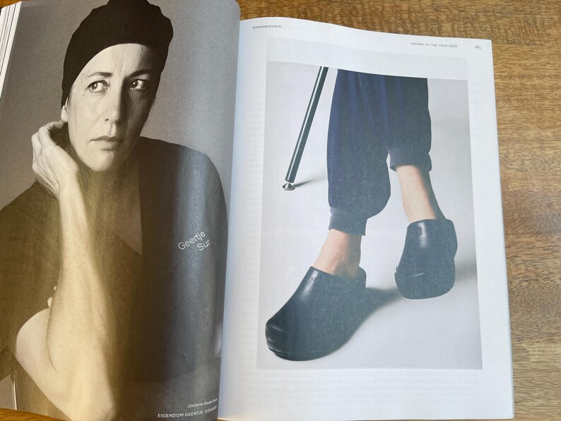 May include: Black and white magazine spread featuring a portrait of a person wearing a black beanie and top. The text "Geertje Sur" is visible. The opposite page shows a person wearing dark blue pants and black shoes.