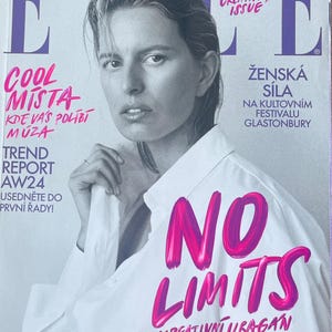 May include: Elle magazine cover featuring a woman in a white shirt. The cover has the text "The Creativity Issue" and "No Limits" in pink. Other text includes "Cool Mista" and "Trend Report AW24".