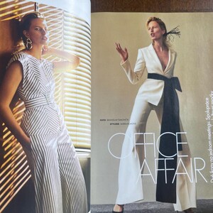 May include: A fashion magazine spread featuring two models. One model wears a white and black striped jumpsuit. The other model is in a white suit with a black sash. The text "OFFICE AFFAIR" is visible.