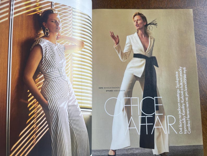May include: A fashion magazine spread featuring two models. One model wears a white and black striped jumpsuit. The other model is in a white suit with a black sash. The text "OFFICE AFFAIR" is visible.