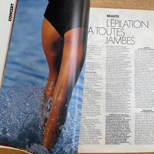 May include: A magazine page featuring a photo of legs emerging from water, with a black swimsuit bottom. The water creates a splash effect. The magazine's title is "BEAUTE L'EPILATION A TOUTES JAMBES".