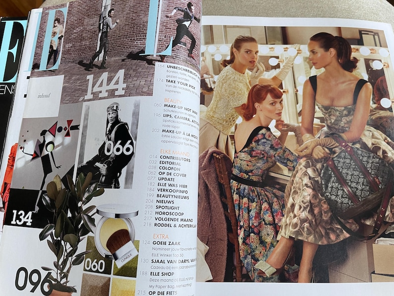 May include: A magazine spread featuring fashion and beauty content. The pages display images of models, makeup, and fashion editorials. Numbers and text are visible, including "ELLE" and "144".