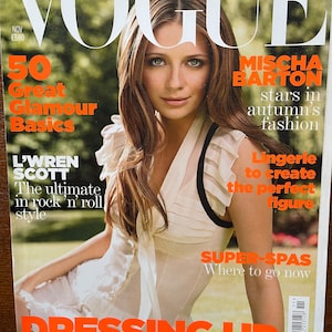 May include: A November issue of Vogue magazine featuring Mischa Barton on the cover. The cover displays the text VOGUE, 50 Great Glamour Basics, L'Wren Scott, The ultimate in rock 'n' roll style, DRESSING UP, and Red-dress power, new evening looks.