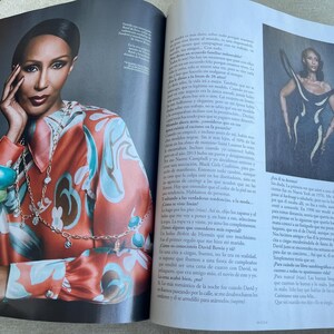 Puede incluir: Una foto de revista con una mujer que lleva una camisa de seda estampada en tonos naranja, turquesa y marr&oacute;n. Est&aacute; adornada con collares superpuestos y pulseras gruesas. La imagen forma parte de un art&iacute;culo de revista.