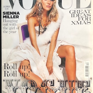 May include: A December issue of Vogue magazine featuring Sienna Miller on the cover. The cover text includes VOGUE, GREAT IDEAS FOR XMAS, SIENNA MILLER, Hanging out with the girl of the year, Roll up! Roll up!, and FASHION PANTOMIME.