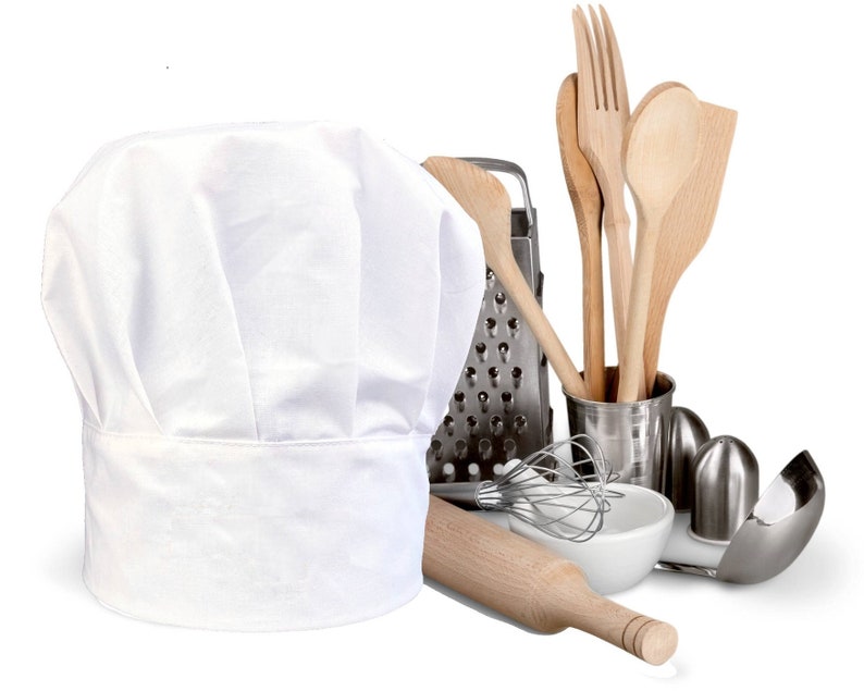 May include: A white chef's hat, a wooden rolling pin, a metal grater, a white ceramic bowl, a whisk, a set of wooden spoons, and a metal salt and pepper shaker set.