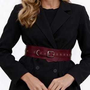 This Wide Leather Belt Handmade is crafted from genuine leather to beautifully define the waist. Designed as a womens waist belt leather style, it works perfectly as a leather belt for dress outfits and everyday looks. The burgundy leather adds elegance, while the wide design offers comfort, durability, and timeless style for modern ladies.