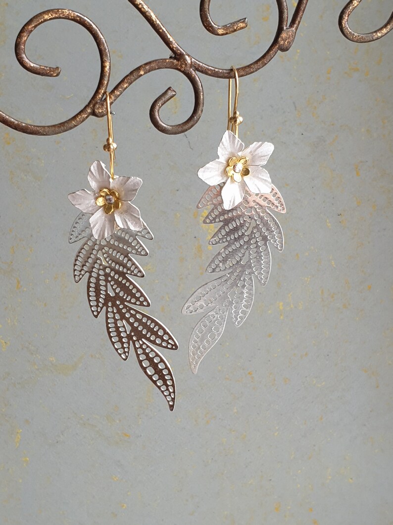Long silver branch with a white flower