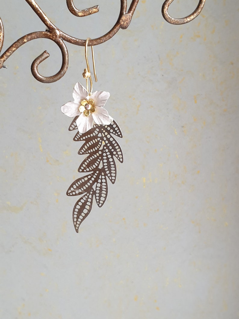 Long silver branch with a white flower