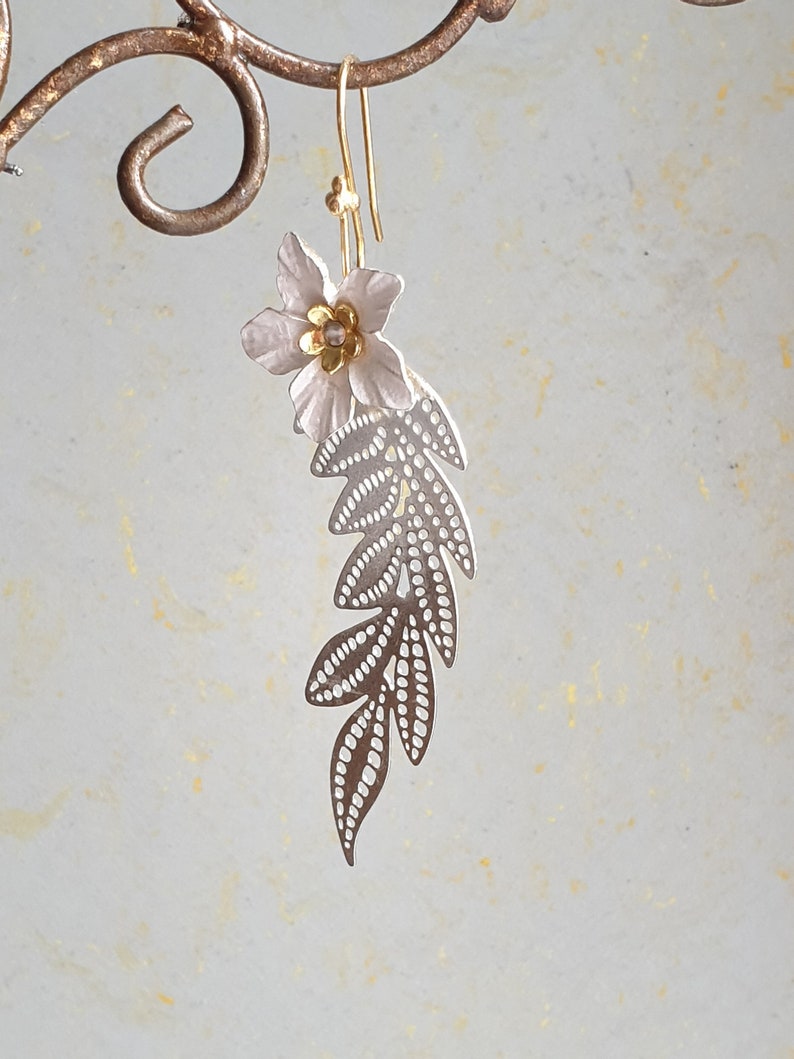 Long silver branch with a white flower