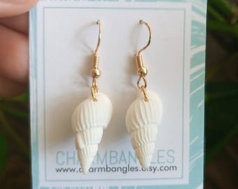 May include: White seashell earrings with gold hooks. The earrings are displayed on a white card with the text "Charm Bangles" and "www.charmbangles.etsy.com".