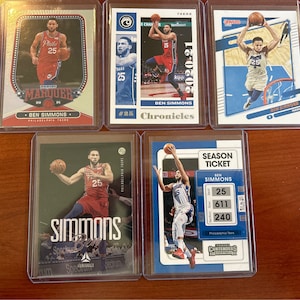 May include: Five trading cards featuring a basketball player, Ben Simmons, in different poses and uniforms. The cards are from different sets, including "Marquee", "Chronicles", and "Season Ticket".