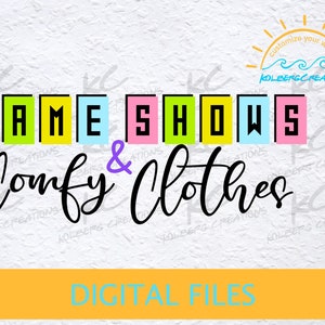 May include: Digital file download for a design that says "Game Shows & Comfy Clothes" in colorful block letters with a purple ampersand. The text is on a white background.