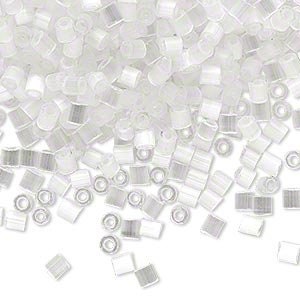 May include: A large pile of small, clear, glass seed beads. The beads are round and have a hole in the center. They are perfect for jewelry making.