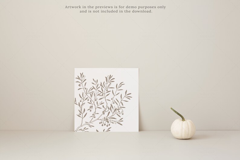 May include: A square print featuring a brown olive branch design on a white background. A small white gourd with a green stem sits to the right. The text at the top says, "Artwork in the previews is for demo purposes only and is not included in the download."