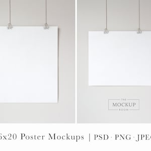 May include: Two blank white 16x20 inch posters hanging from the ceiling with string and clips. The posters are against a light gray background.