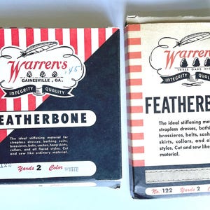 May include: Two boxes of Warren's Featherbone stiffening material. The boxes are red and white striped with black accents. The text on the boxes reads "Warren's Featherbone" and includes information about the product, such as the number of yards and color.