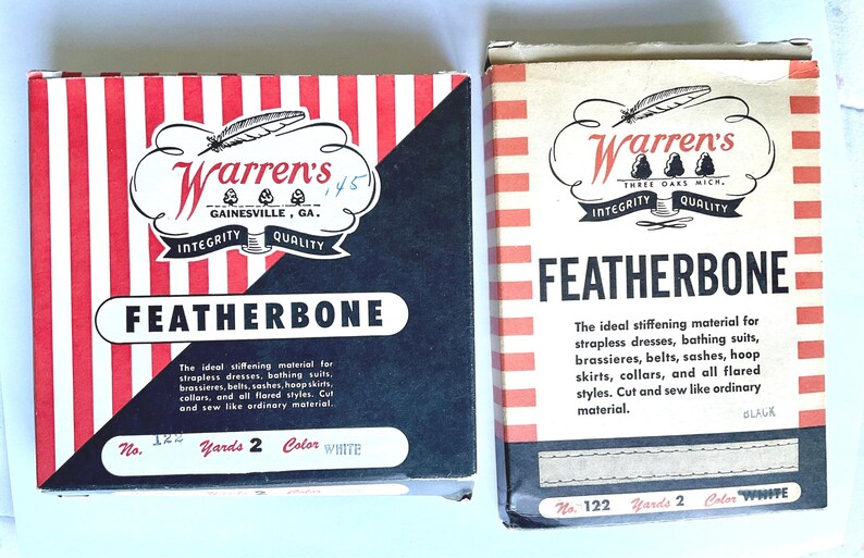 May include: Two boxes of Warren's Featherbone stiffening material. The boxes are red and white striped with black accents. The text on the boxes reads "Warren's Featherbone" and includes information about the product, such as the number of yards and color.