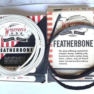 May include: Two spools of white Featherbone stiffening material for clothing. The spools are labeled "Warren's" and "Featherbone". The text on the spools reads "The ideal stiffening material for strapless dresses, bathing suits, brassieres, belts, sashes, hoop skirts, collars, and all flared styles. Cut and sew like ordinary material."