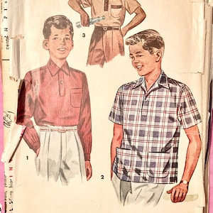 May include: A vintage sewing pattern with illustrations of boys' shirts. The shirts include a red striped long-sleeved shirt, a plaid short-sleeved shirt, and a tan short-sleeved shirt. The pattern also shows the shirt details.