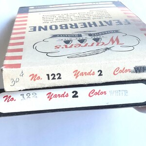 May include: Two boxes of white Featherbone thread, labeled "Warren's" with the number "122", "Yards 2", and "Color WHITE".