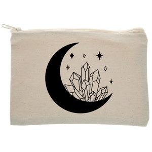 May include: A white canvas zippered pouch with a black crescent moon and a cluster of crystals. The moon is filled in black and the crystals are outlined in black. There are small stars and diamonds scattered around the moon and crystals.