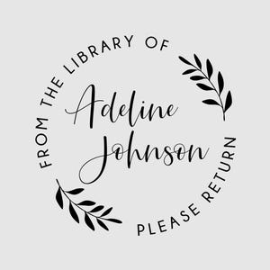 May include: A circular black ink stamp design on a light gray background. The text reads FROM THE LIBRARY OF ADELINE JOHNSON PLEASE RETURN. The design features a circular border with two black leaf sprigs positioned on the upper right and lower left.