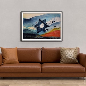 May include: A framed abstract watercolor painting of a blue Star of David with a white center, set against a background of blue, white, and orange watercolor washes. The painting is framed in black and has the artist's signature in the bottom left corner.