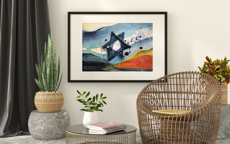 May include: A framed watercolor painting of a blue Star of David against a background of blue, green, yellow, and orange watercolor washes. The painting is in a black frame and is hanging on a white wall.