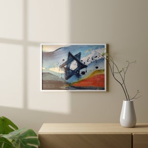 May include: Abstract watercolor painting in a white frame. The painting features a blue and black star of David shape with a white background. The background also features blue, yellow, and red watercolor washes.