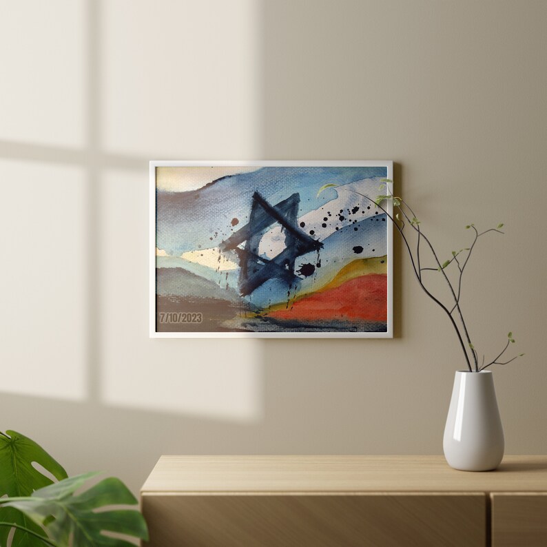 May include: Abstract watercolor painting in a white frame. The painting features a blue and black star of David shape with a white background. The background also features blue, yellow, and red watercolor washes.