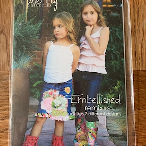 May include: Pink Fig patterns Embellished Remix #30 includes 7 different designs. Two girls are wearing skirts and boots. One girl is wearing a pink tank top and the other is wearing a white tank top.