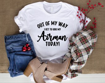 Op de afbeelding: Wit T-shirt met zwarte tekst die "Out of my way I get to hug my Airman today!" luidt.