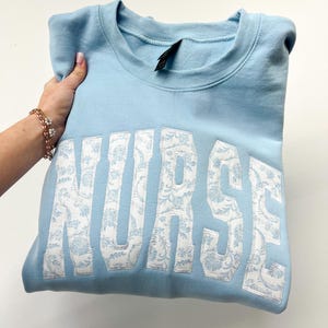 NURSE Embroidered Applique Light Blue Grand Millennial sweatshirt. NURSE blue floral sweatshirt embroidery Tee shirt