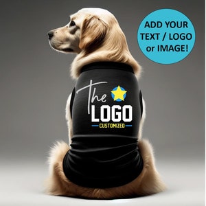 May include: A golden retriever dog wearing a black tank top with the text "The Logo - Customized" and a yellow star. The text "Add your text / logo or image!" is in a blue circle above the dog.