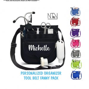 May include: Black personalized tool belt fanny pack with the name "Michelle" in white script. The organizer has multiple pockets and a strap. Additional color options are shown, including blue, red, purple, pink, gray, green, and blue.