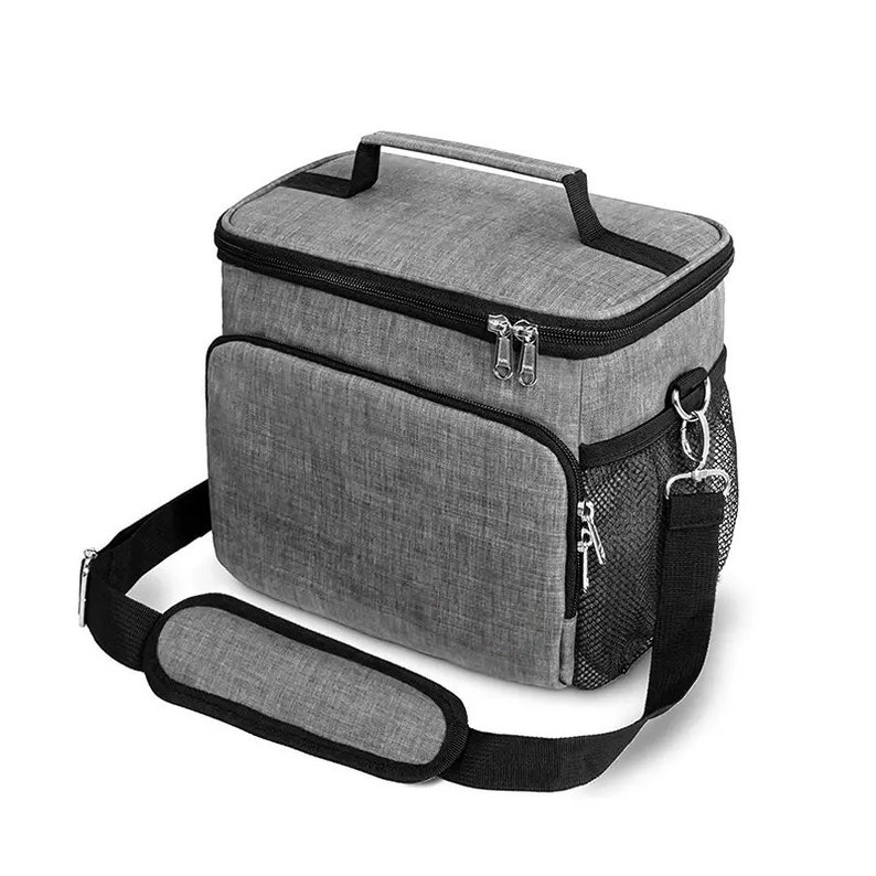 May include: A gray insulated lunch bag with a black zipper, a black handle, and a black adjustable shoulder strap. The bag has a mesh pocket on the side.