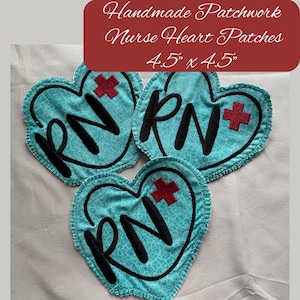 May include: Three turquoise blue heart-shaped fabric patches with a black embroidered "RN" and a red embroidered plus sign. Each patch measures 4.5 inches by 4.5 inches. Handmade patchwork nurse heart patches.