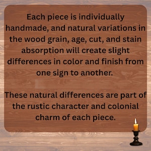 May include: A wooden sign with text about handmade variations in wood grain, age, and stain. The sign has a rustic character and colonial charm. A small candle in a black holder is in the bottom right corner.