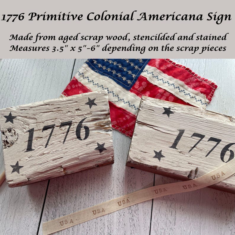 May include: Primitive Americana sign made from aged wood, stenciled with the year 1776 and star accents. The sign measures approximately 3.5 inches by 5 to 6 inches. A small American flag and a ribbon with "USA" text are also visible.