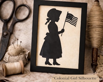 May include: Black framed print featuring a silhouette of a colonial girl holding a flag with stars and stripes. The print is part of the Colonial Silhouettes Collection. The image includes text: "Colonial Girl Silhouette" A Tribute to Early America.