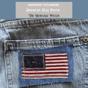 May include: Close-up of a denim pocket with a handmade American flag patch. The patch features a dark blue rectangle with a pattern of small flowers and a red and white striped section. Text at the top reads "HANDMADE PATCHWORK AMERICAN FLAG PATCH THE HERITAGE PATCH."