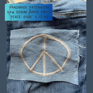 May include: Handmade patchwork raw denim hippie patch "Peace Sign" 4.75" x 6" on a pair of blue jeans.