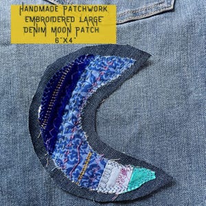 May include: Handmade patchwork denim moon patch, embroidered with blue, pink, and green fabric. The patch is 6 inches by 4 inches.