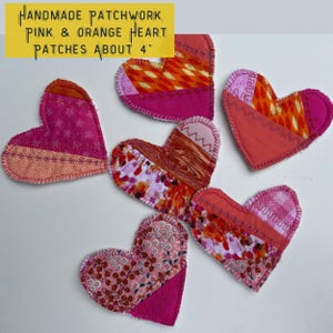 May include: Handmade patchwork heart patches in pink and orange, each approximately 4 inches. The heart-shaped patches feature various fabric patterns and colors, including floral, geometric, and solid hues, with visible stitching.