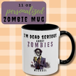 May include: A white ceramic mug with a black interior and handle. The mug features the text "I'M DEAD SERIOUS ABOUT ZOMBIES" and a zombie illustration. The mug also has the text "MICHAEL" at the bottom. The mug is labeled "11 OZ personalized ZOMBIE MUG".