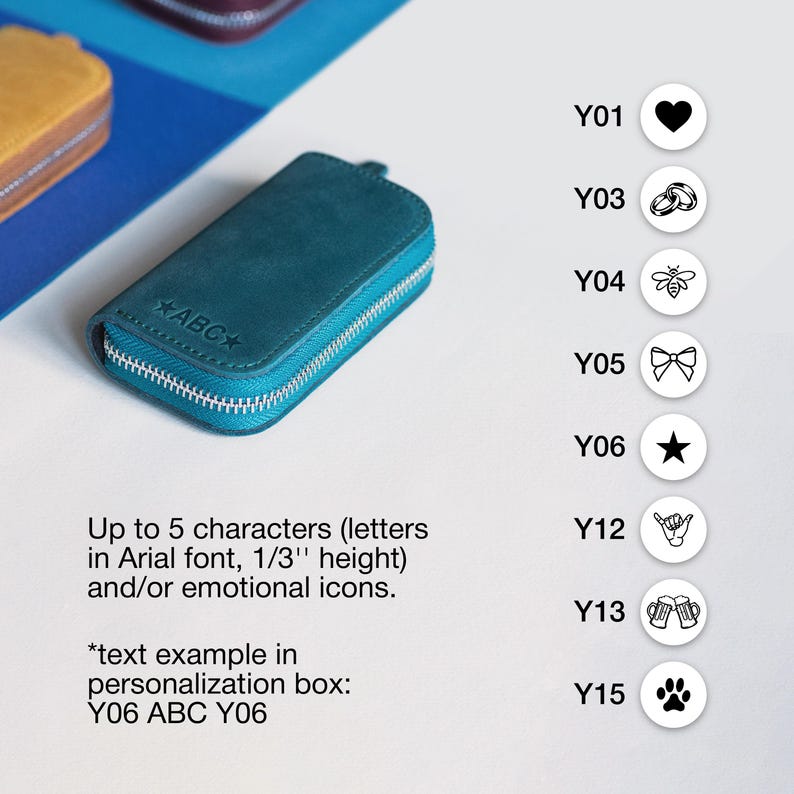 May include: Teal zippered key case with silver zipper and embossed text. The text reads "ABC" with stars on either side. The image also shows a selection of icons, including a heart, rings, a bee, a bow, a star, a hang loose sign, beer mugs, and a paw print.