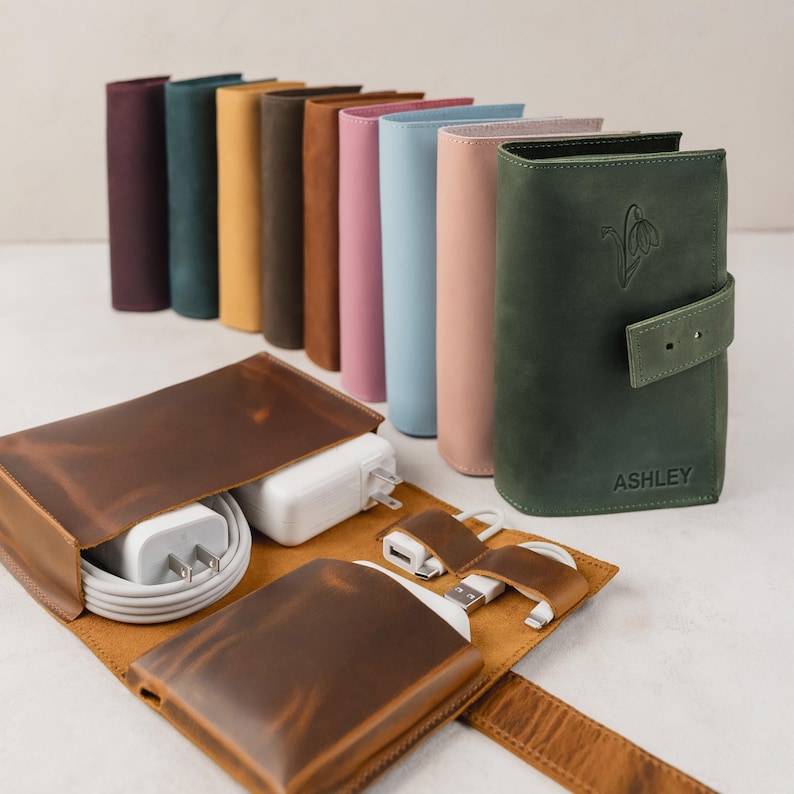 Personalized leather travel cable organizer with birth month flower embossing, perfect for tech accessories storage.